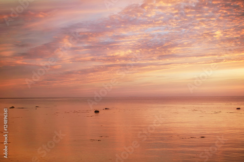 view of beautiful sunset above the sea in purple, gold and pink