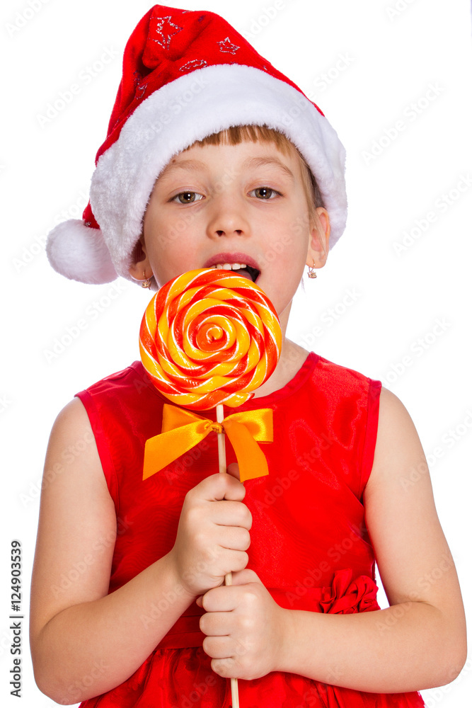 Christmas portrait of a little girl, Santa hat with candy StockFoto