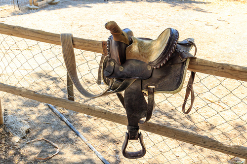 Saddle hung on the fence