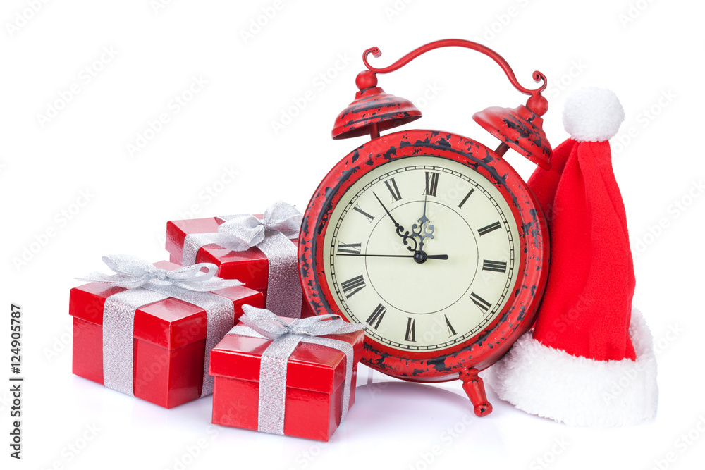Christmas clock, gift boxes and santa hat StockFoto Adobe Stock