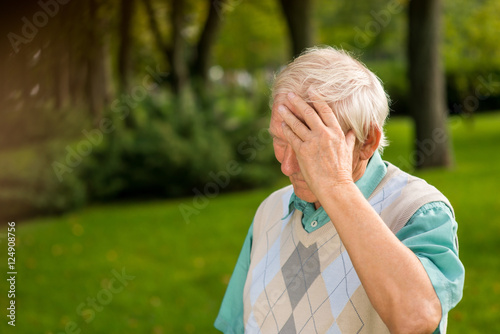 Senior man touching his forehead. Elderly male outdoors. Sad and lonely. I was wrong.