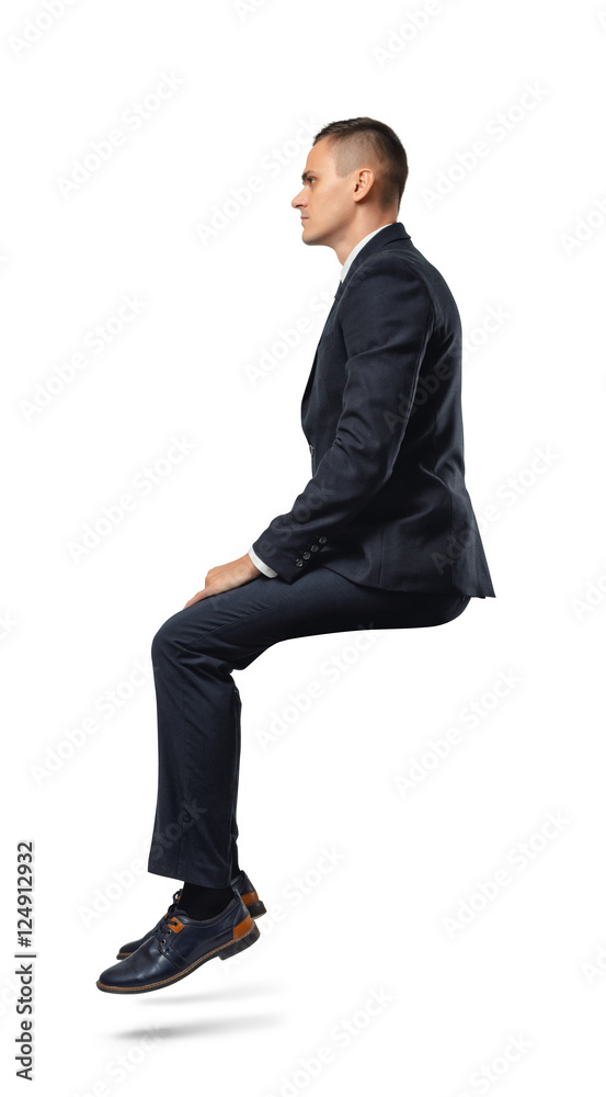 Businessman in profile in sitting position isolated on the white background. Businessman in profile in sitting position isolated on the white background.