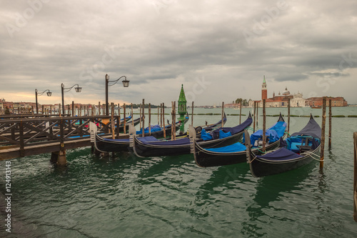 Traditional Venetian gondola - with San Giorgio Maggiore church. San Marco, Venice, Italy © mikhailberkut