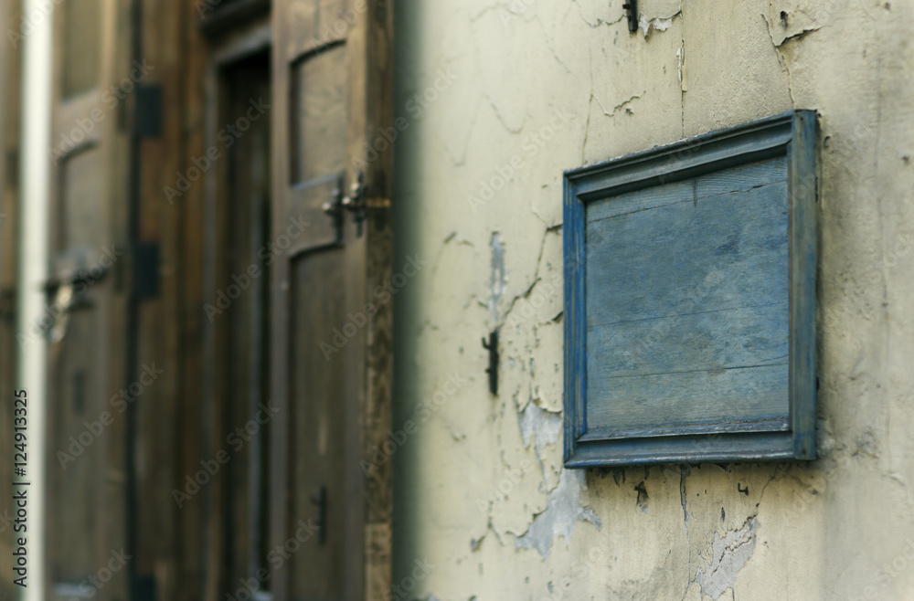 Blank wooden board on an old building wall