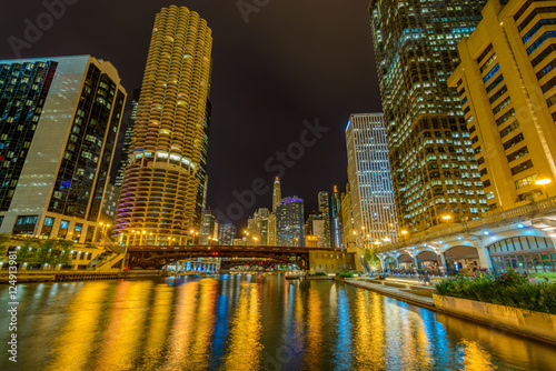 Chicago River skyline with urban skyscrapers at night, IL, USA