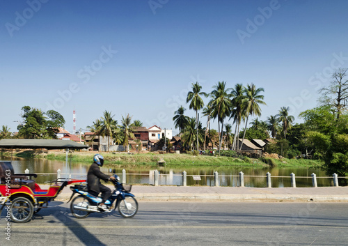 asian tuk tuk taxi by riverside of siem reap cambodia