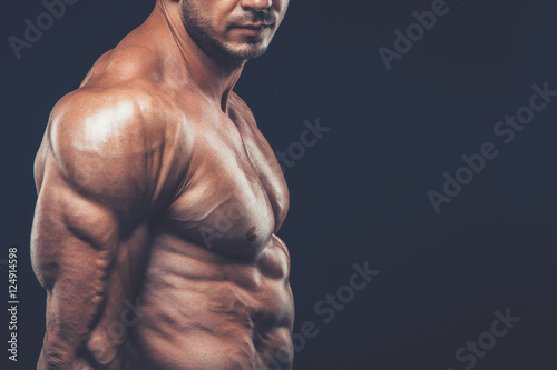 strong athletic man on black background © satyrenko