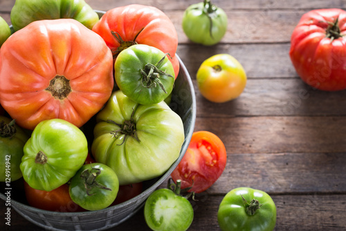 Colorful organic tomatoes on wooden table 