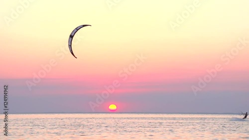 Kitesurf on the background of a beautiful sunset.   Slow motion 240 fps.