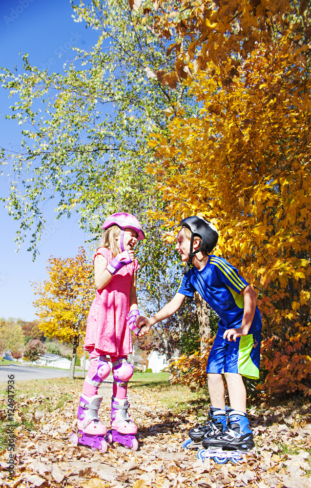 Happy children on roller blades at autumn Happy children on roller blades at autumn