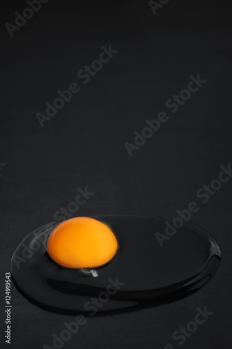 Raw egg on the black table