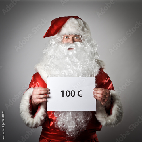 Santa Claus is holding a white paper in his hands. One hundred E