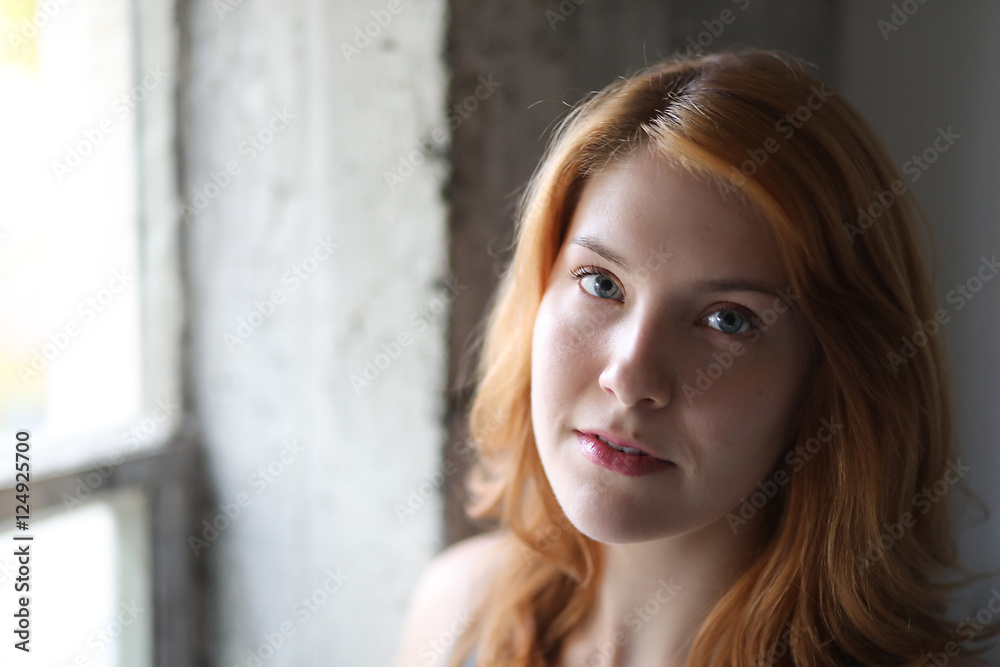 Fototapeta premium Beautiful Young Woman with Blue Eyes