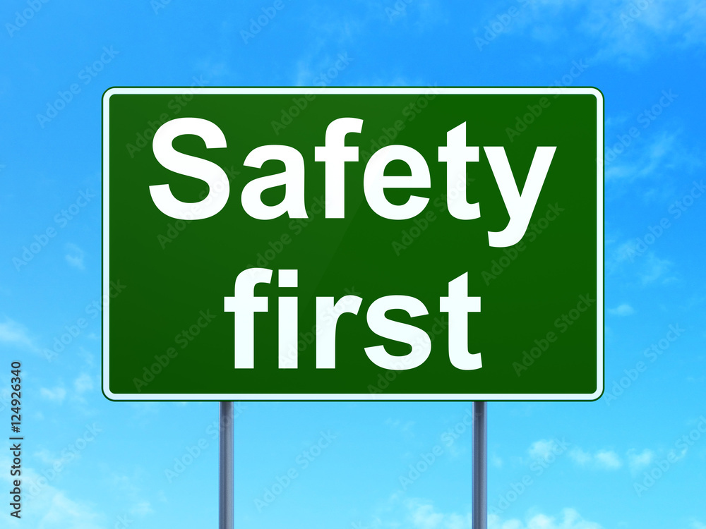 Security concept: Safety First on road sign background Security concept: Safety First on road sign background