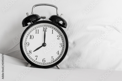 Still life with vintage alarm clock on bed ( alarm clock show 8