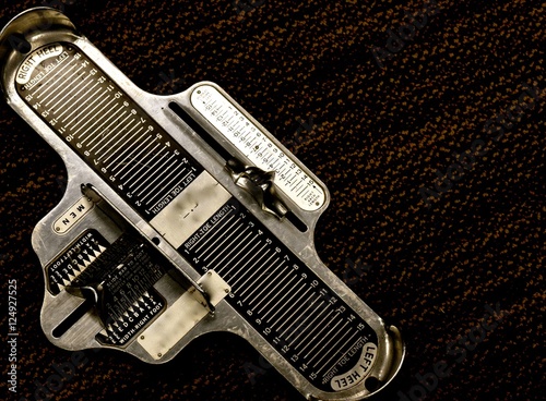 Foot Measure / a Metal tool to measure foot size to determine shoe size.
