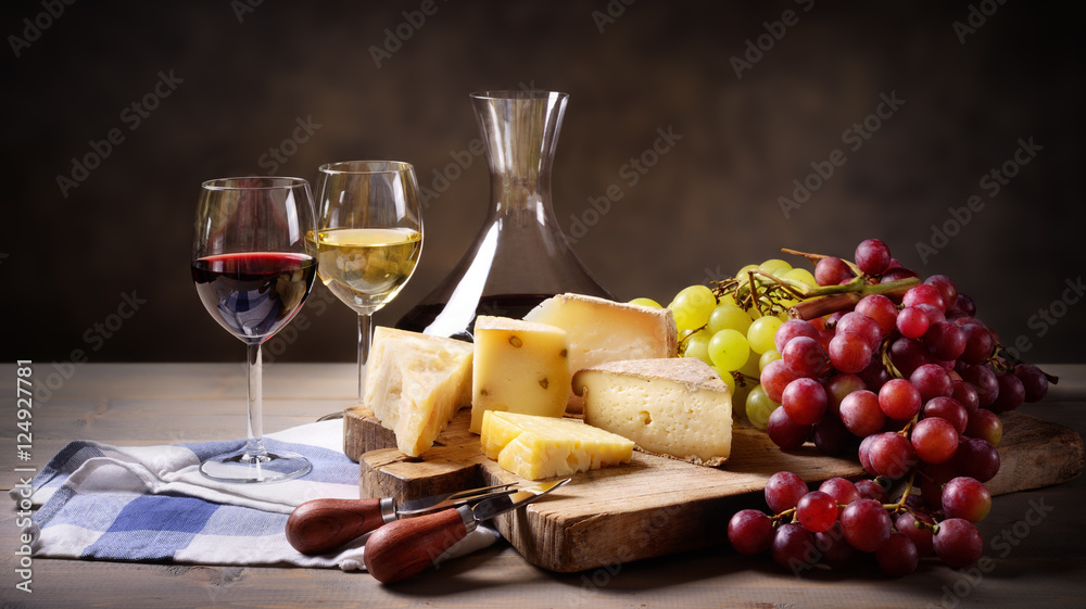 Fototapeta premium Wine, grapes and cheese platter, space for text.