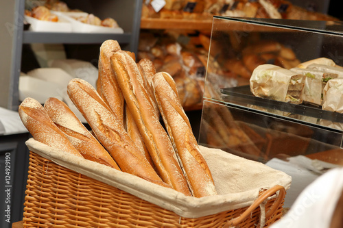 French baguettes in wicker basket in bakery photo