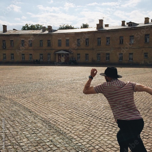 man in hat  running in the street. late concept photo