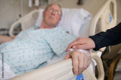 holding hands with elderly patient at hospital photo