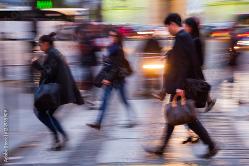 people crossing a street at night