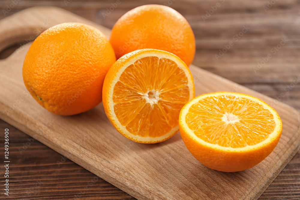 Fresh oranges on cutting board Fresh oranges on cutting board