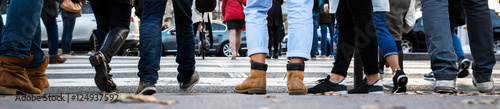 people waiting at the pedestrian crossing