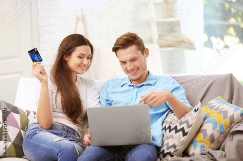 Happy couple with laptop sh...