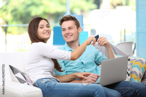 Happy couple with laptop sh...