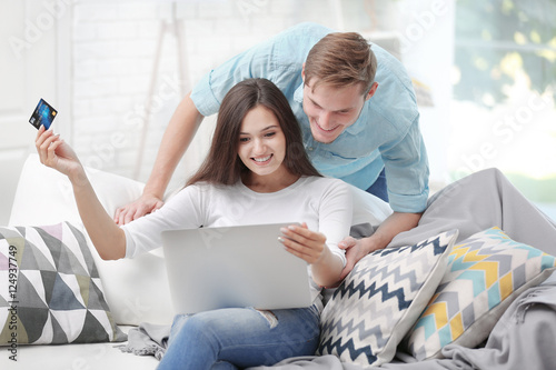Happy couple with laptop sh...