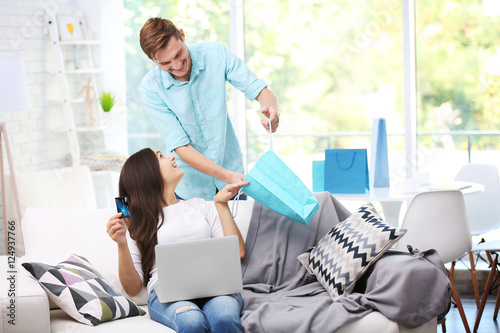 Happy couple online shoppin...