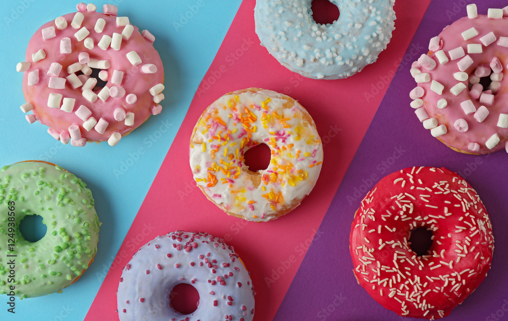 Tasty donuts with sprinkles on colorful background Tasty donuts with sprinkles on colorful background