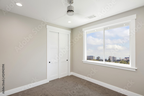 Empty room interior with, ceiling fan, carpet with small walk-in