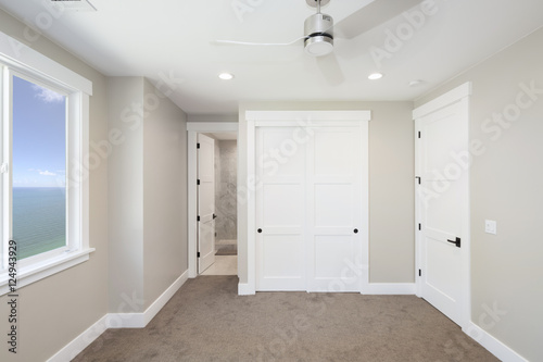 Empty room interior with  ceiling fan  carpet with small walk-in