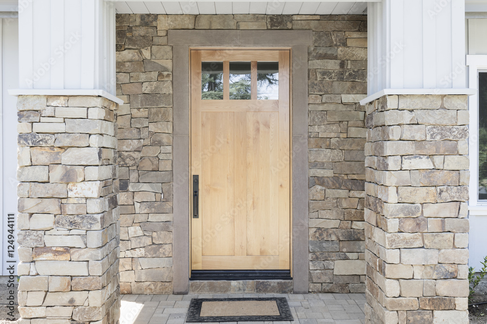 Fototapeta premium Wood front door of a home. View of a rustic front door in modern