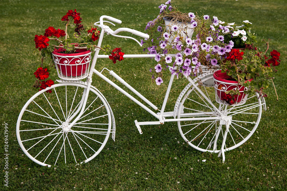 Decorative bicycle with flowers on grass Decorative bicycle with flowers on grass