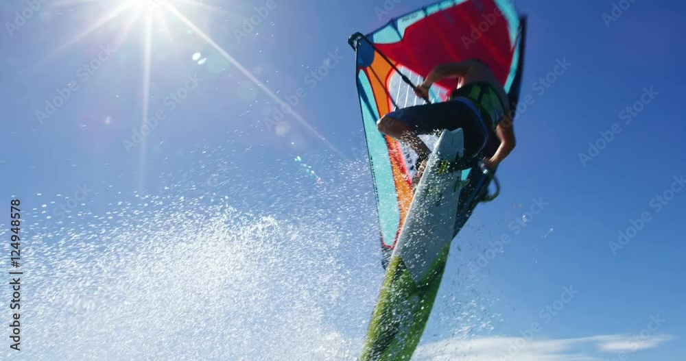 Windsurfer gets big air jumping off wave, Extreme sport