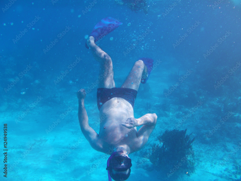 men underwater in caribbean sea