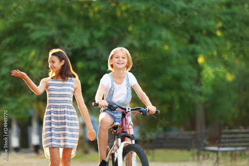 Cheerful girl riding bicycl...