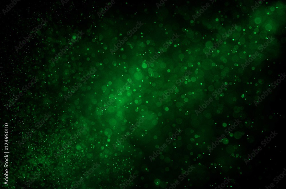 Dark green abstract background with bokeh.
