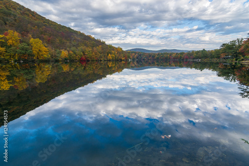 Lake at Bear Mountain in New York State in the autumn season during peak foliage with a clear reflection in the water