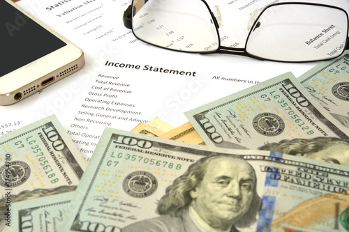Photography income statement report on the table