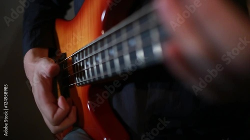 Bass guitar player close up playing virtuoso bass with fingers and slap