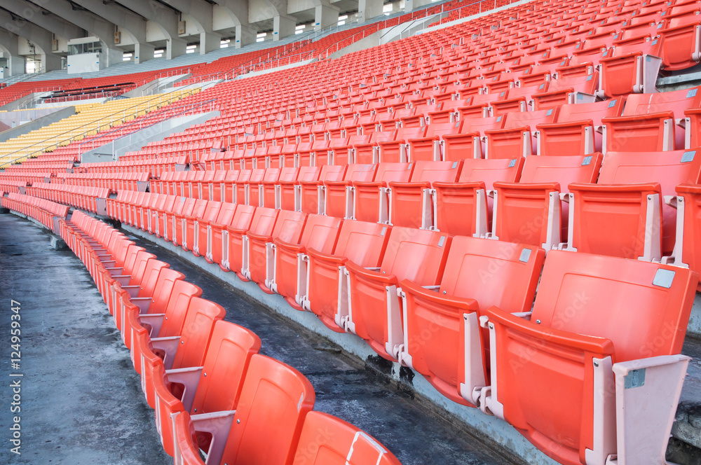 Obraz premium Empty orange seats at stadium,Rows of seat on a soccer stadium