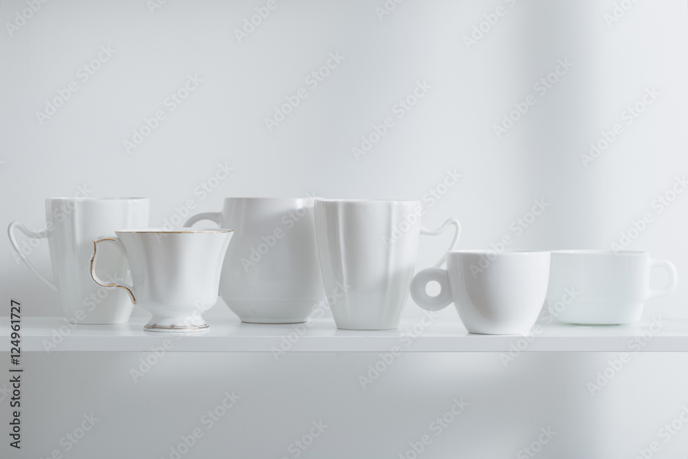 Fototapeta premium Clean cups on wooden shelf
