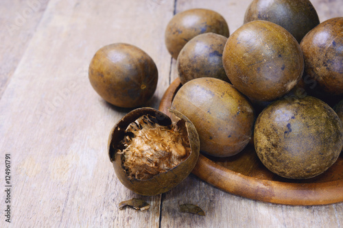luo han guo (monk fruit, fructus momordicae, momordica grosvenori, siraitia grosvenorii) on wooden background.