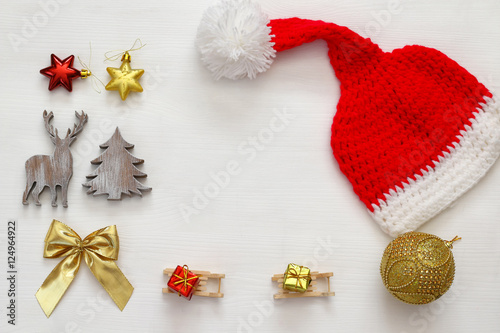 Santa claus red hat next to wooden decorations © tomertu