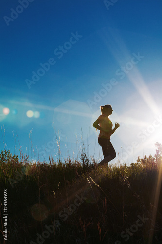 Fototapeta Naklejka Na Ścianę i Meble -  Silhouette of a female jogger