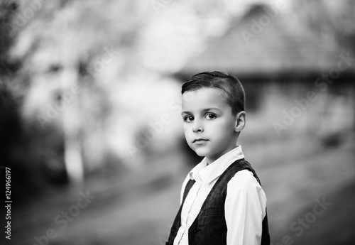portrait of a boy with black eyes, black and white photo 