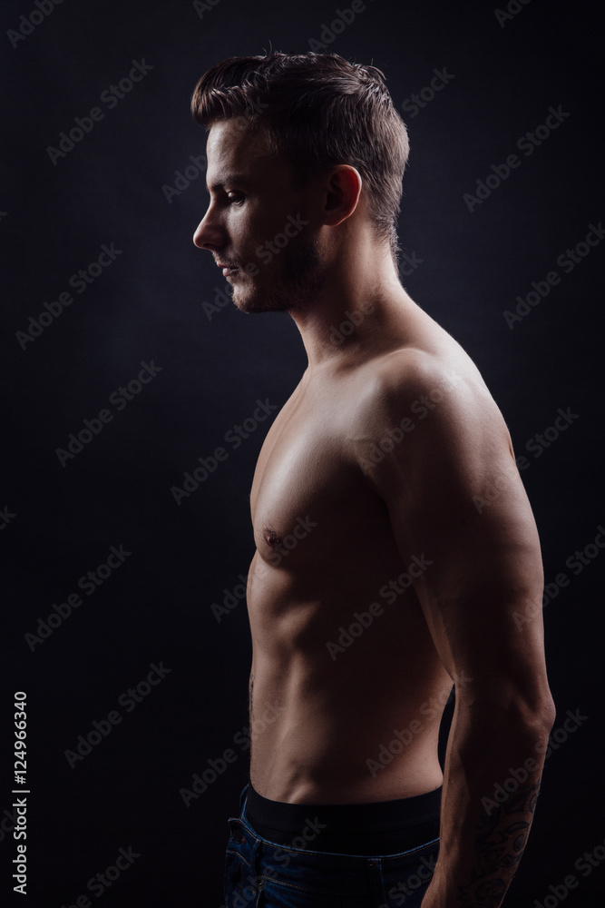 Fototapeta premium Handsome fitness man side view
